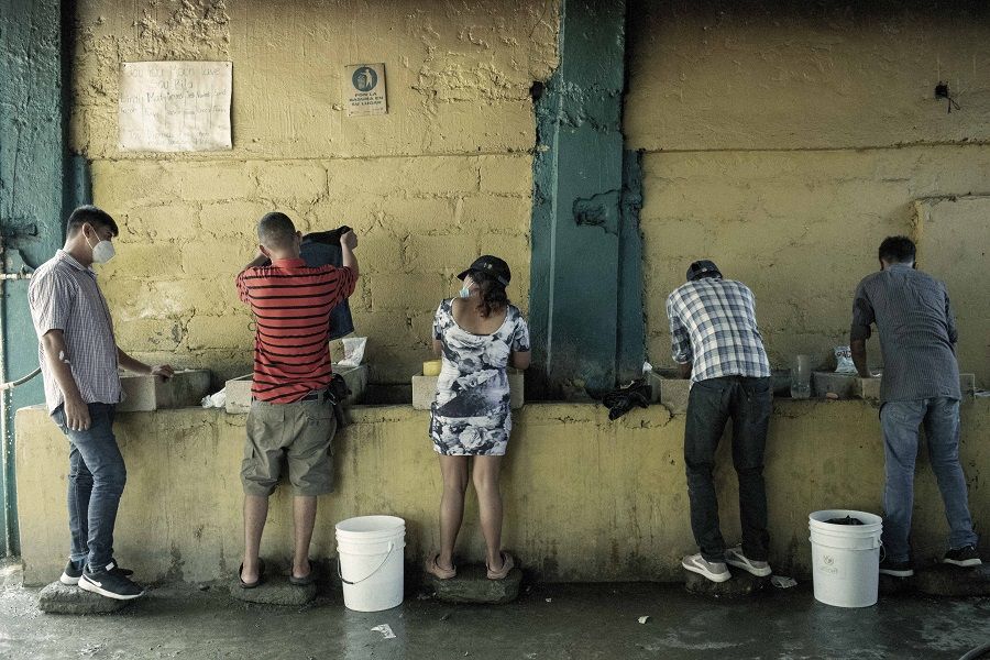 Migrants and asylum seekers wash clothing at a shelter in Tapachula, Chiapas state, Mexico, on 29 January 2021. (Nicolo Filippo Rosso/Bloomberg)