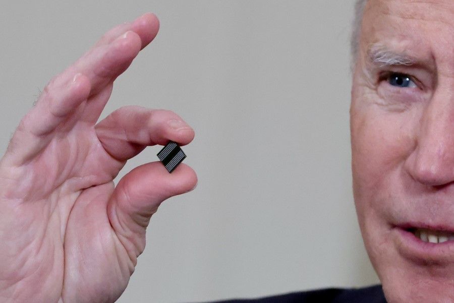 US President Joe Biden holds a semiconductor chip as he speaks prior to signing an executive order, aimed at addressing a global semiconductor chip shortage, in the State Dining Room at the White House in Washington, US, 24 February 2021. (Jonathan Ernst/Reuters)
