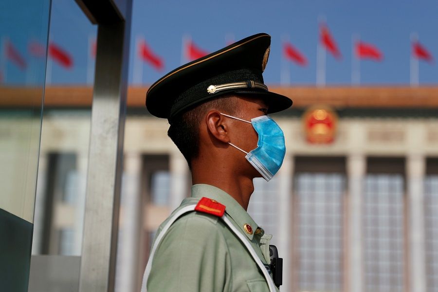 A paramilitary police officer wearing a face mask following the Covid-19 outbreak, stands guard outside the Great Hall of the People before the opening session of the National People's Congress (NPC) in Beijing, China, on 22 May 2020. (Carlos Garcia Rawlins/Reuters)