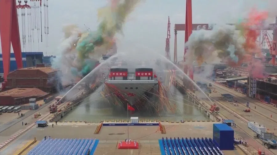 This screen grab made from a video released by Chinese state broadcaster CCTV shows the launch ceremony of the Fujian, a People's Liberation Army (PLA) aircraft carrier, at a shipyard in Shanghai on 17 June 17, 2022. (CCTV/AFP)