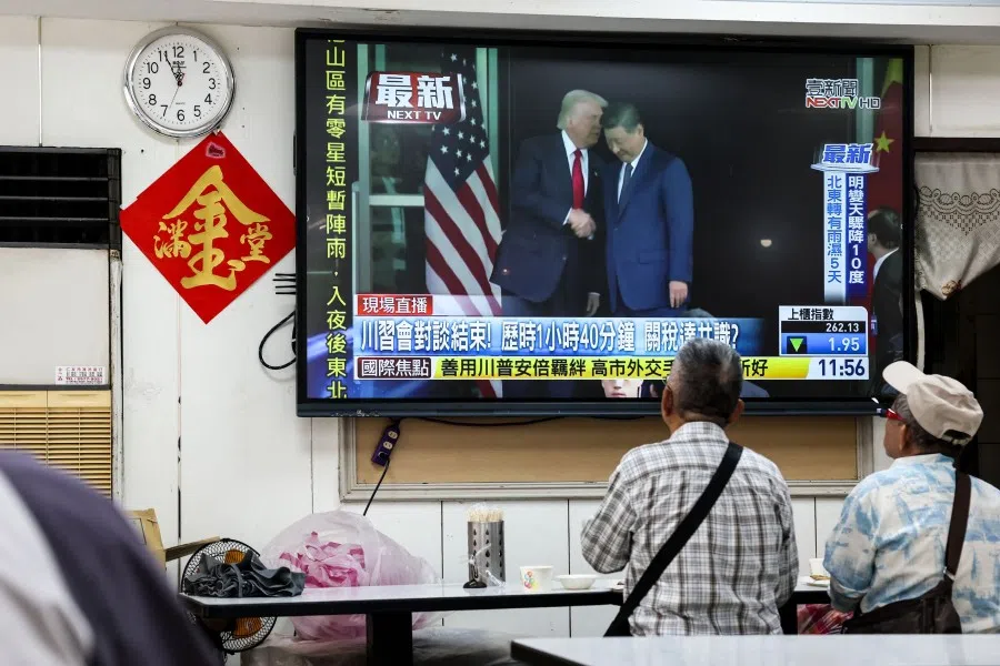 People watch a news programme in Taipei on 30 October 2025 showing the meeting of US President Donald Trump and China’s President Xi Jinping in South Korea. (I-Hwa Cheng/AFP)