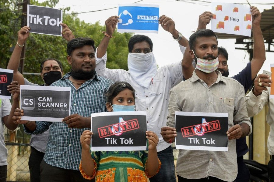 Members of the City Youth Organisation hold posters with the logos of Chinese apps in support of the Indian government for banning the wildly popular video-sharing 'Tik Tok' app, in Hyderabad on 30 June 2020. (Noah Seelam/AFP)