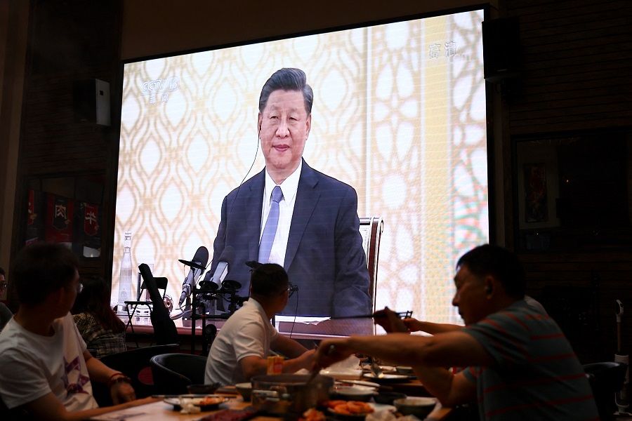 Customers dine near a giant screen broadcasting news footage of Chinese President Xi Jinping attending a meeting with Russian President Vladimir Putin, on the sidelines of the Shanghai Cooperation Organisation (SCO) summit in Uzbekistan, at a restaurant in Beijing, China, 16 September 2022. (Tingshu Wang/Reuters)
