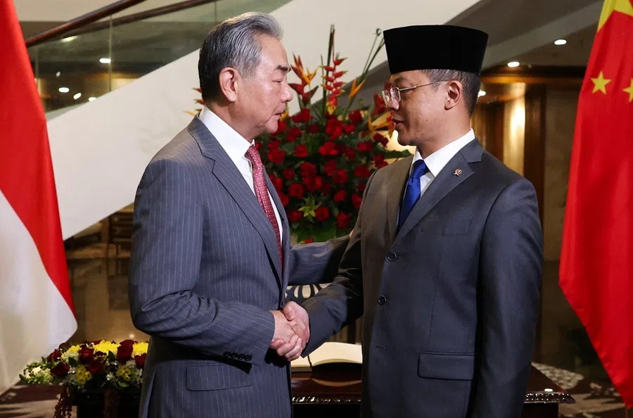 China's Foreign Minister Wang Yi (left) shakes hands with his Indonesian counterpart Sugiono as they meet at the Foreign Ministry in Jakarta, Indonesia, 21 August 2026.