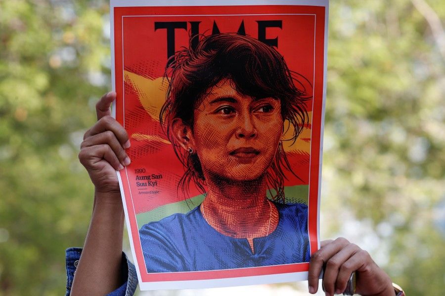 A person holds up a placard depicting Aung San Suu Kyi after the military seized power in a coup in Myanmar, outside United Nations venue in Bangkok, Thailand, 3 February 2021. (Soe Zeya Tun/REUTERS)