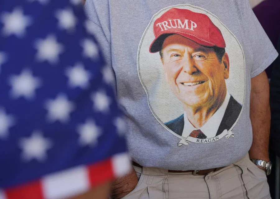 A person wears a t-shirt depicting former US President Ronald Reagan wearing a Trump cap in Reading, Pennsylvania, US, on 9 October 2024. (Jeenah Moon/Reuters)