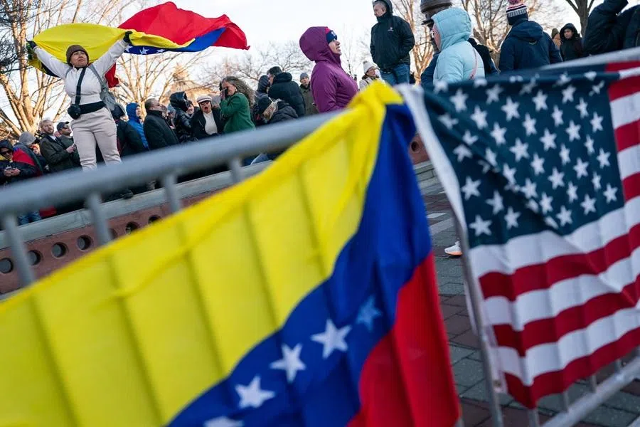 A woman holds a Venezuelan flag as people gather outside the US Capitol, in Washington, DC, US, on 15 January 2026. (Elizabeth Frantz/Reuters)