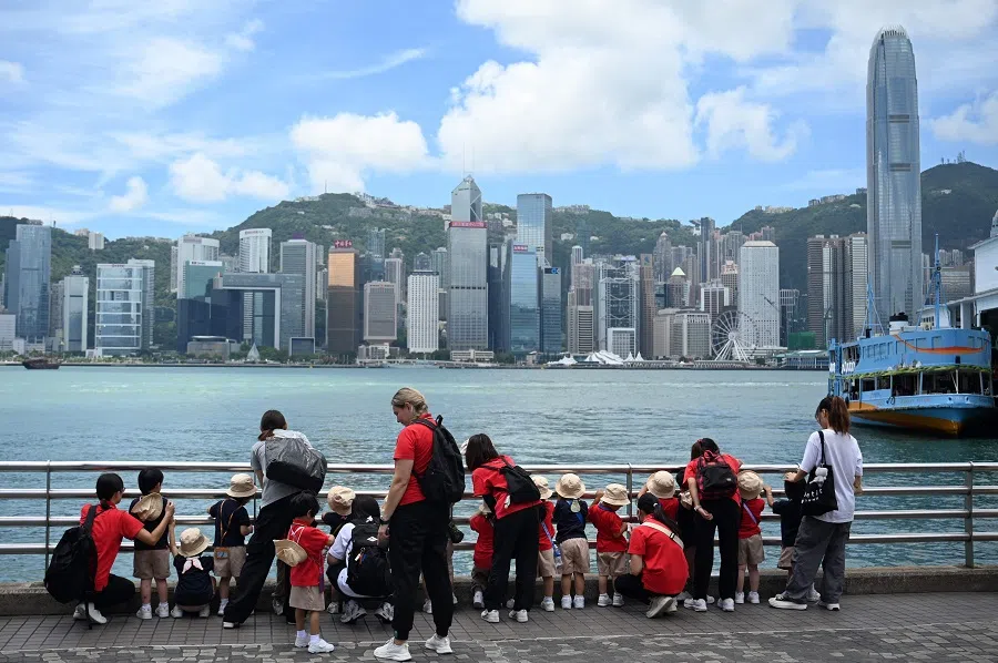 School children line up for a view of Victoria Harbour in Hong Kong on 15 May 2025. (Peter Parks/AFP)