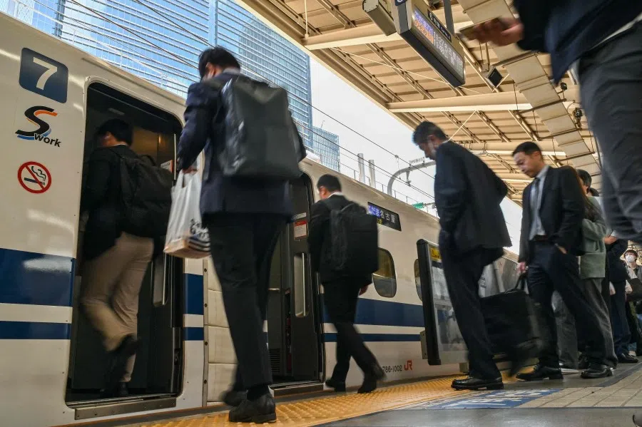 Passengers get on a Kodama bullet train, or “shinkansen” service to the city of Nagoya at Tokyo station in central Tokyo on 17 April 2024. (Richard A. Brooks/AFP)