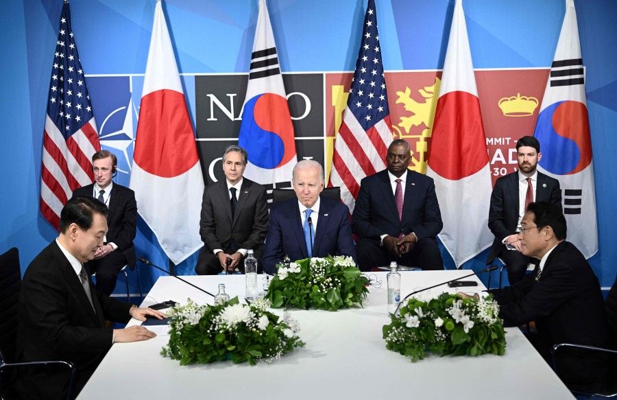 US President Joe Biden (centre) with South Korea's President Yoon Suk-Yeol (left) and Japan's Prime Minister Fumio Kishida (right) during a trilateral meeting on the sidelines of the NATO summit at the Ifema congress centre in Madrid, on 29 June 2022. (Brendan Smialowski/AFP)