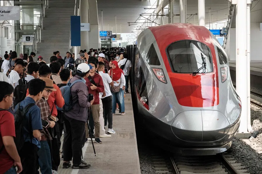 People take pictures with the first car of the Jakarta-Bandung high-speed train during a week-long public trial phase at the Tegalluar station in Bandung, West Java, Indonesia, on 17 September 2023. (Yasuyoshi Chiba/AFP)