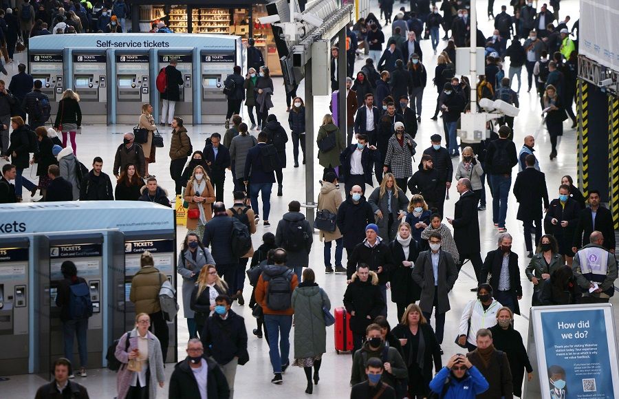 People walk through Waterloo station during morning rush hour in London, Britain, 3 November 2021. (Henry Nicholls/Reuters)