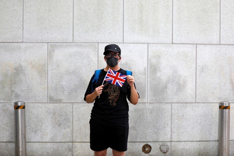 A man holds the British Union Jack during a protest outside the British Consulate-General office in Hong Kong. (Willy Kurniawan/REUTERS)