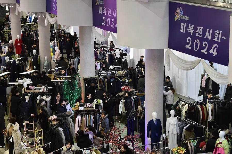 People visit the garment exhibition 2024 at the Okryu Exhibition House in Pyongyang on 23 December 2024. (Kim Won Jin/AFP)