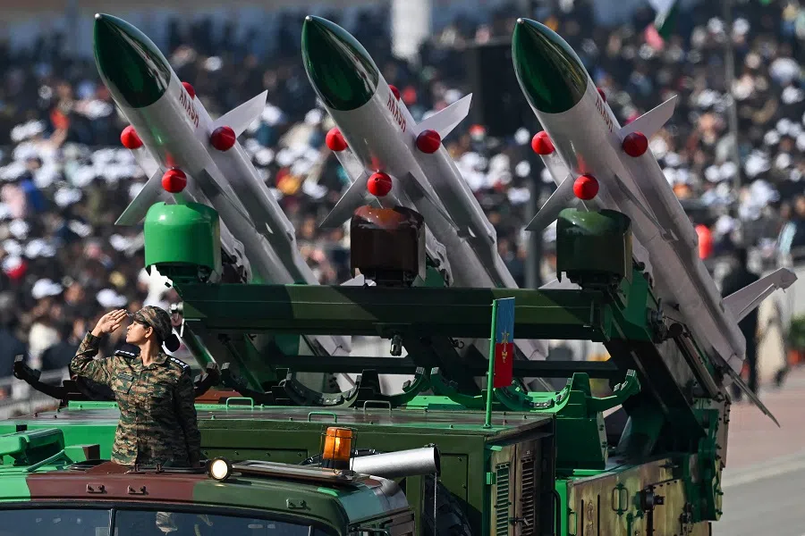 A soldier salutes next to an Akash missile system during India’s 76th Republic Day parade in New Delhi on 26 January 2025. (Sajjad Hussain/AFP)