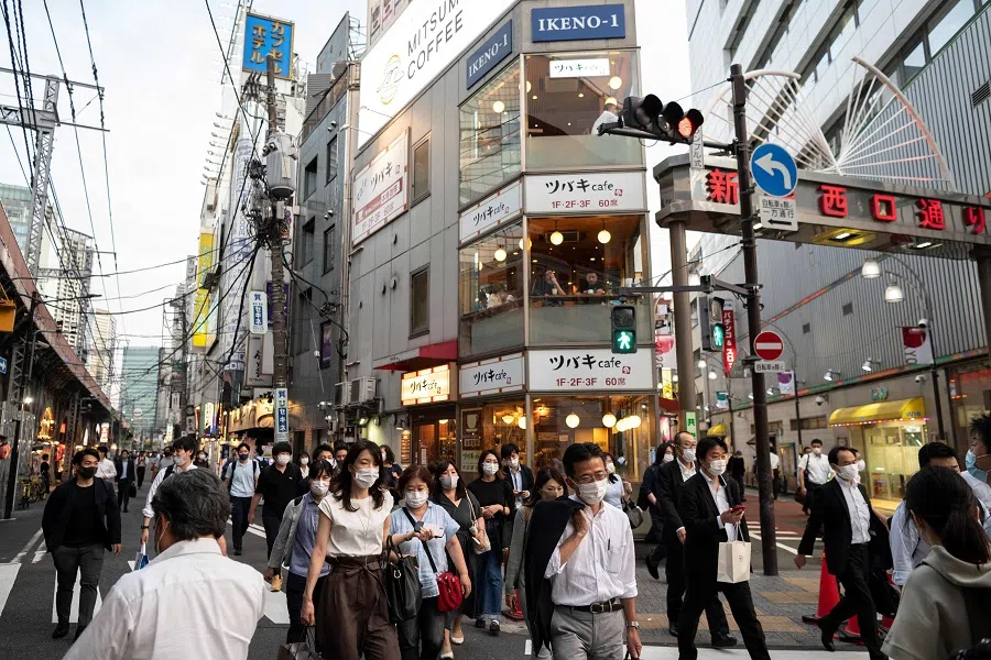 People walk in the street in Tokyo's Shinbashi area on 21 June 2021 in Japan. (Charly Triballeau/AFP)