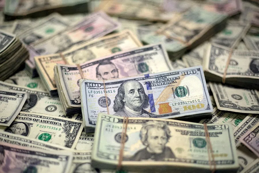 US dollar banknotes are seen in this photo illustration taken 12 February 2018.