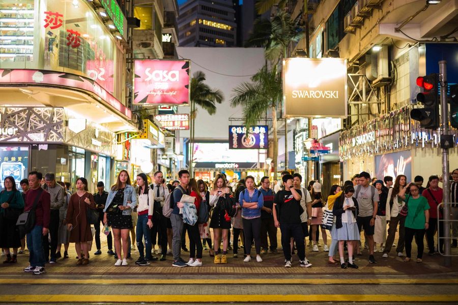 Hong Kong is an international metropolis and both Chinese and English are the official languages. Pictured here are pedestrians preparing to cross a road in the popular shopping district of Causeway Bay in Hong Kong. (Anthony Wallace/AFP)