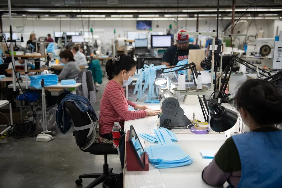 Workers make protective masks at Kaas Tailored manufacturing facility in Mukilteo, Washington, US, on 26 March 2020. (Chona Kasinger/Bloomberg)