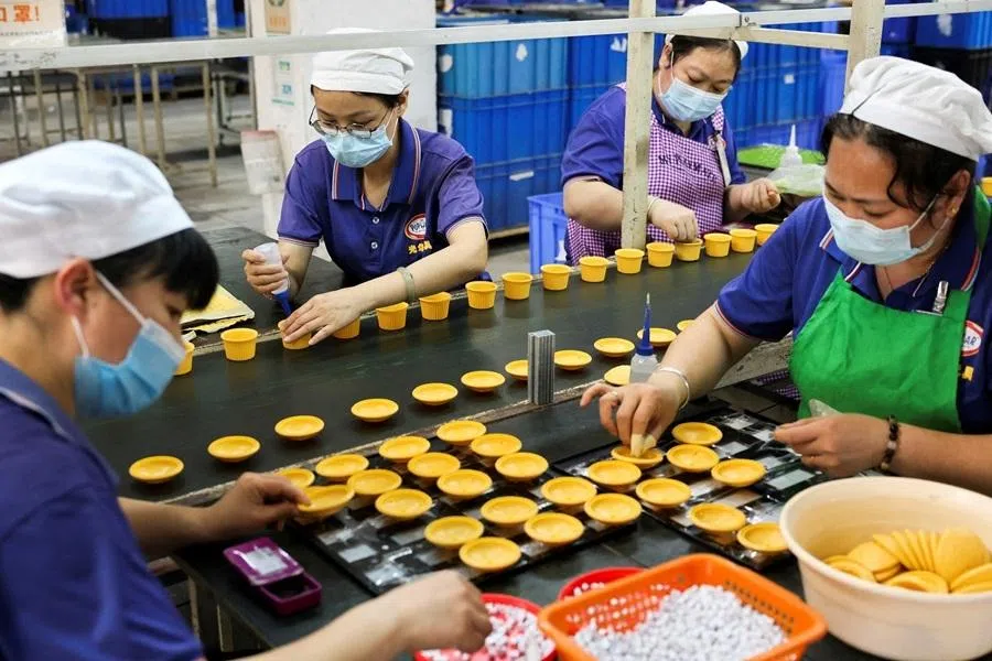 Employees of Shaoguan Guanghua Plastic & Hardware Products Co., Ltd work to assemble toy parts in the factory in Shaoguan, Guangdong province, China, 9 May 2025.
