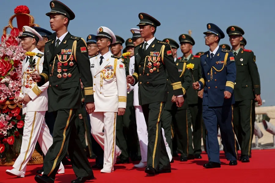 Members of the Chinese People's Liberation Army (PLA) arrive to lay flowers at the Monument to the People’s Heroes during a ceremony to mark Martyrs’ Day, a day ahead of the National Day on Tiananmen Square in Beijing, China on 30 September 2025. (Florence Lo/Reuters)
