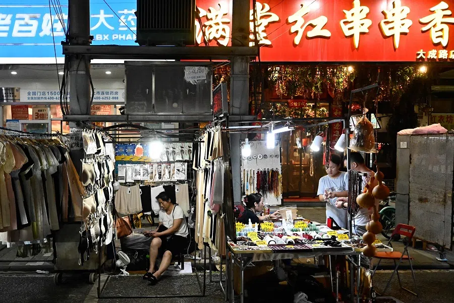 People are seen at the Dacheng Road Night Market in Wuhan, Hubei province, China on 1 August 2024. (Pedro Pardo/AFP)