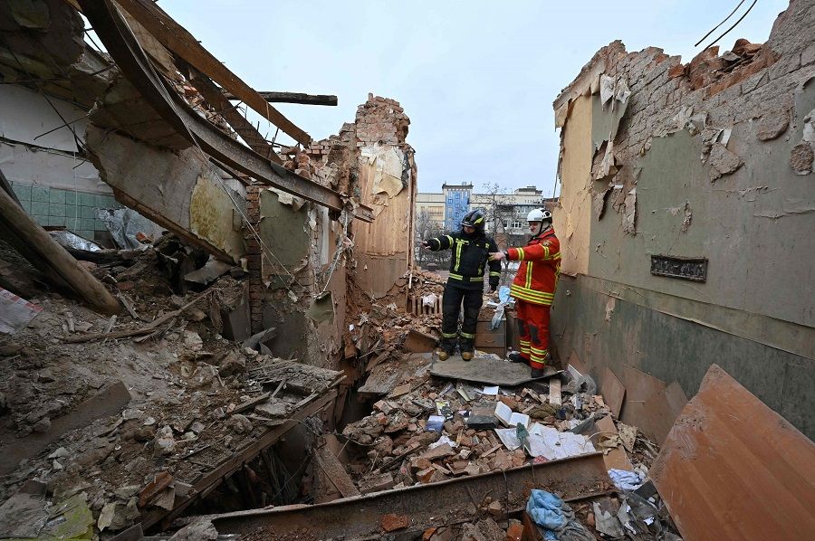 Ukrainian rescuers examine the debris for clearing at a residential building, partially destroyed after a missile strike on Kharkiv, Ukraine, on 30 January 2023, amid the Russian invasion of Ukraine. (Sergey Bobok/AFP)