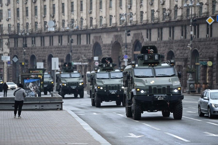 Ukrainian military vehicles move past Independence square in central Kyiv on 24 February 2022. (Daniel Leal/AFP)