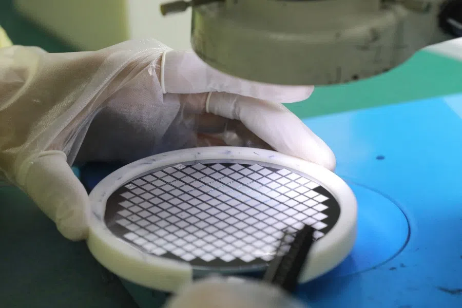 An employee makes a chip at a factory of Jiejie Semiconductor Company in Nantong, in eastern China's Jiangsu province on 17 March 2021. (STR/AFP)