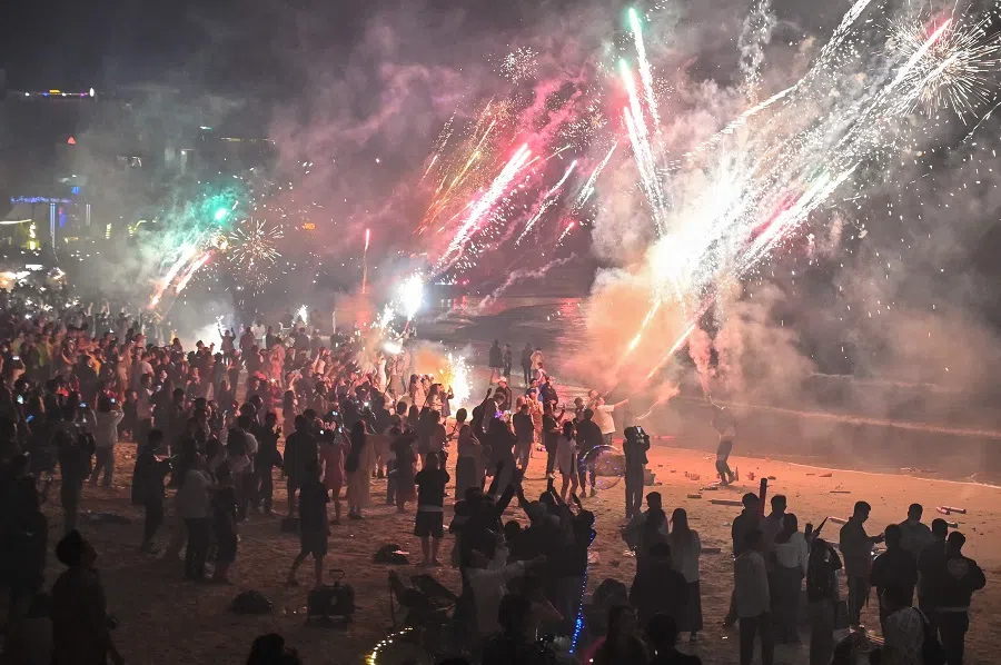 People celebrate the new year with fireworks at Houhai beach, in Sanya, Hainan province, China, on 31 December 2022. (Hector Retamal/AFP)