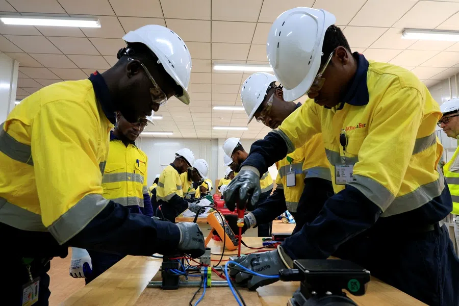Workers operate in a workshop at blocks three and four of the Simandou mine, one of the largest high-grade iron ore deposits, in the Nzerekore region, Guinea, 4 November 2025. (Luc Gnago/Reuters)