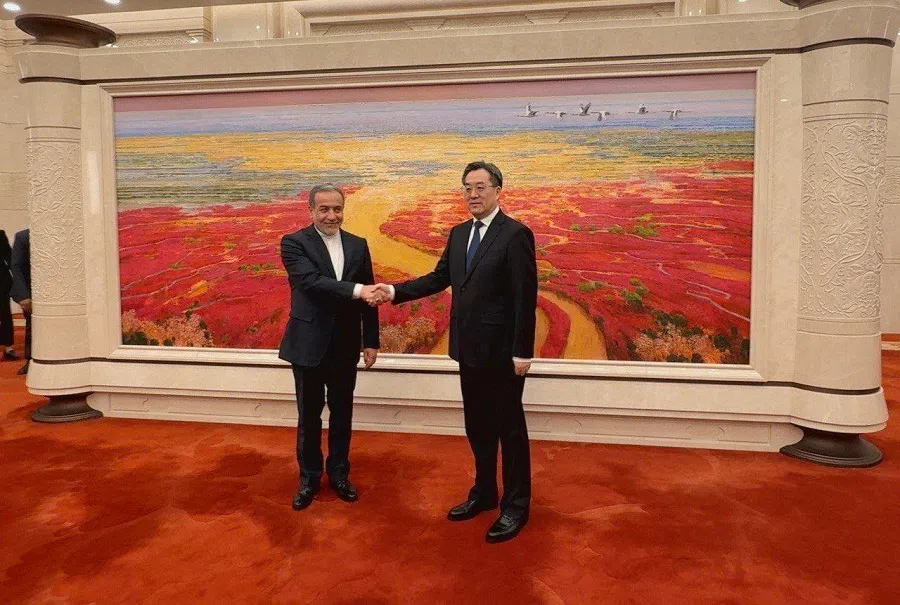 This handout picture provided by the Iranian foreign ministry shows Chinese Vice Premier Ding Xuexiang welcoming Iran’s Foreign Minister Abbas Araghchi in Beijing on 23 April 2025. (Iranian Foreign Ministry/AFP)