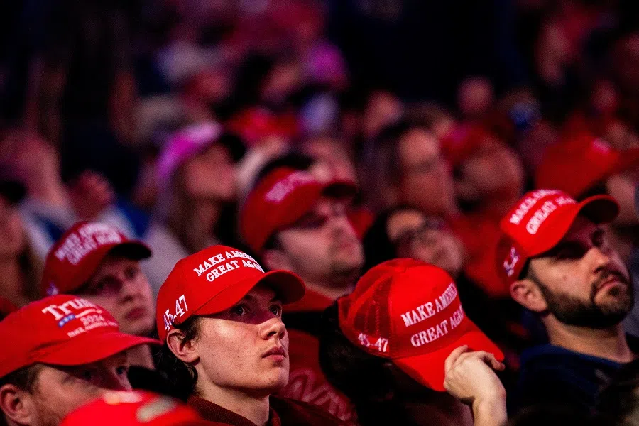 Attendees wearing MAGA caps wait ahead of a campaign rally featuring Republican presidential nominee and former US President Donald Trump in Grand Rapids, Michigan, US, on 4 November 2024. (Emily Elconin/Reuters)