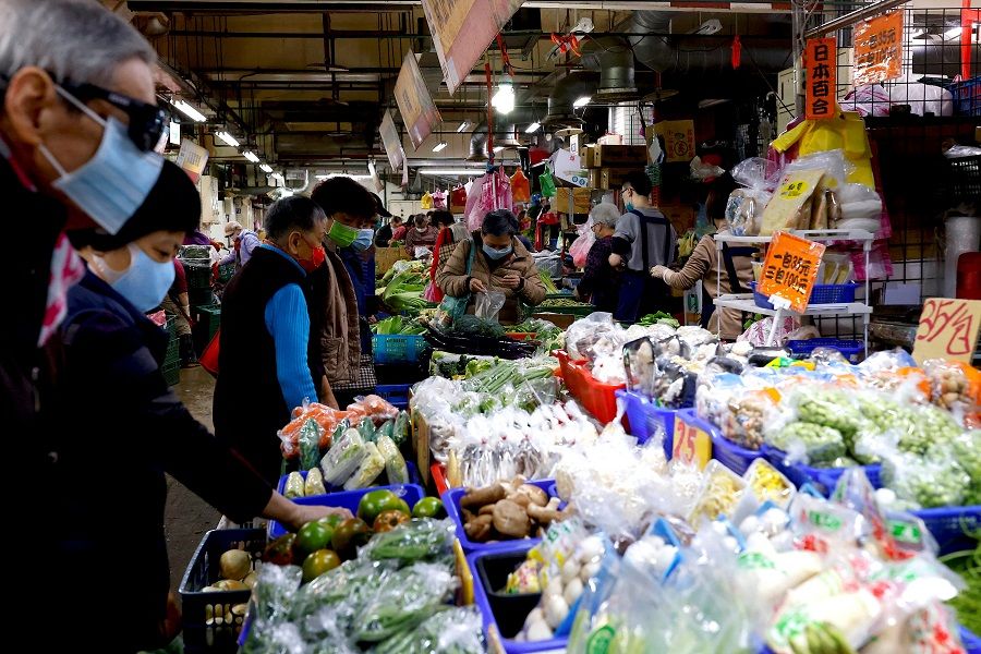 People buy and sell vegetables in Taipei, Taiwan, 17 January 2023. (Ann Wang/Reuters)