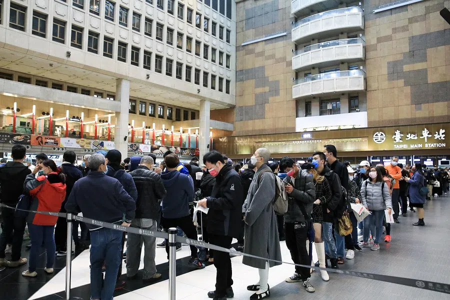 Members of the public wait in line at a vaccination facility administering the Covid-19 vaccine set up at Taipei Main Station in Taipei, Taiwan, on 17 January 2022. (I-Hwa Cheng/Bloomberg)