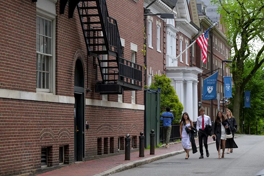 Students walk on the campus of Harvard University in Cambridge, Massachusetts, US, on 23 May 2025. (Faith Ninivaggi/Reuters)