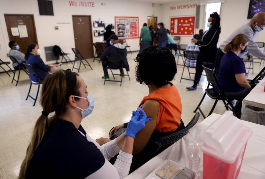 Maryland residents receive the Moderna Covid-19 vaccine through the Anne Arundel County Department of Health at a community Covid-19 vaccination clinic at the Metropolitan United Methodist Church, 23 March 2021, in Severn, Maryland. (Win McNamee/AFP)