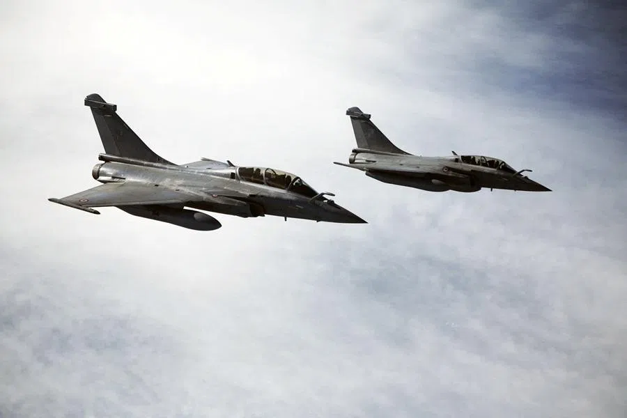 Rafale aircraft follow an MRTT refuelling plane during an air operation moments before the arrival of French President Emmanuel Macron at the nuclear submarines Navy base Ile Longue in Crozon, France, on 2 March 2026. (Yoan Valat/Pool via Reuters)