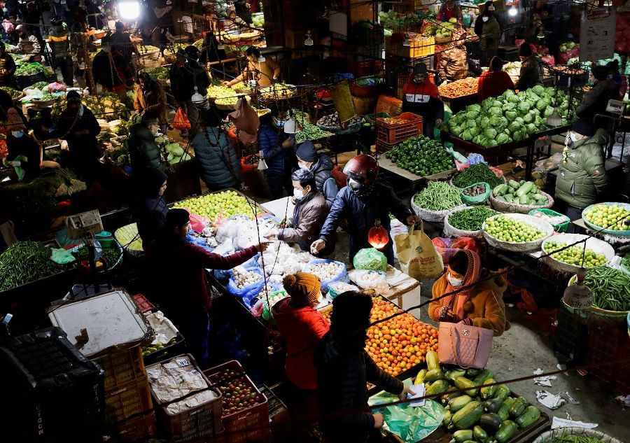 People buy and sell vegetables at a market in Nepal, 19 January 2022. (Navesh Chitrakar/File Photo/Reuters)