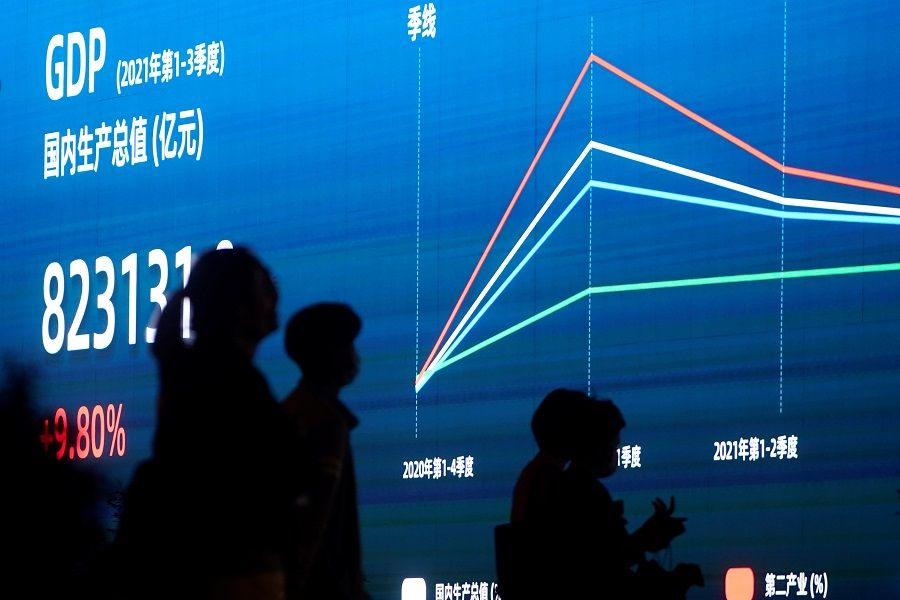 An electronic display showing the China GDP indexes is seen on a street in Shanghai, China, 18 October 2021. (Aly Song/Reuters)