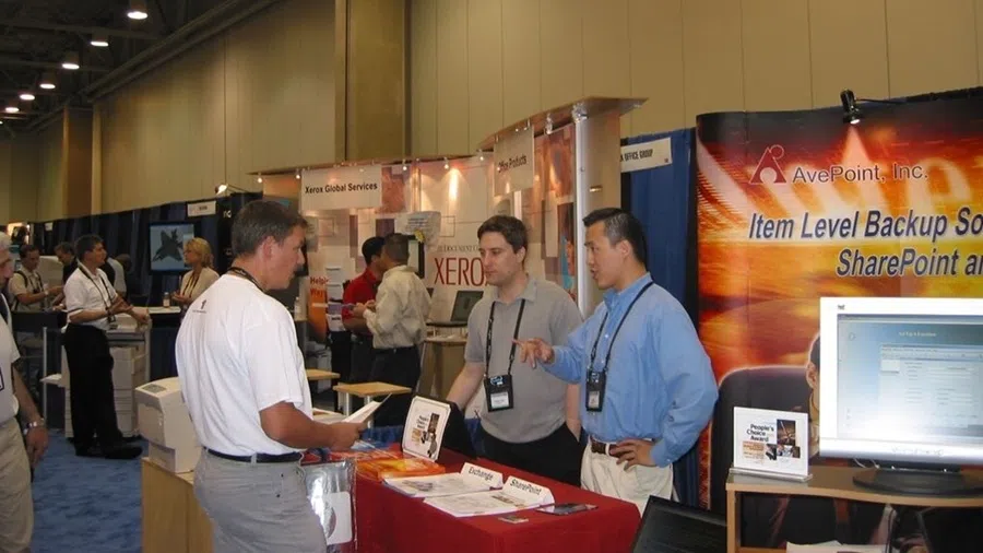 Jiang (far right) at an exhibition booth promoting AvePoint.