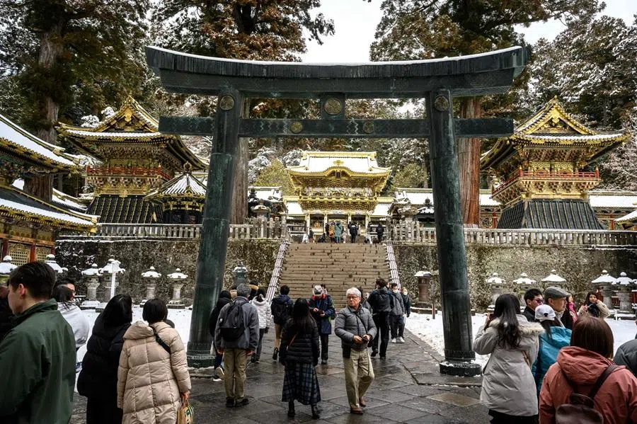 This photograph taken on 10 February 2025 shows tourists visiting the snow covered Toshogu shrine, the final resting place of Ieyasu, the first Tokugawa shogun, a famous tourism spot and UNESCO World Heritage Site in Nikko city of Tochigi prefecture. (Mladen Antonov/AFP)