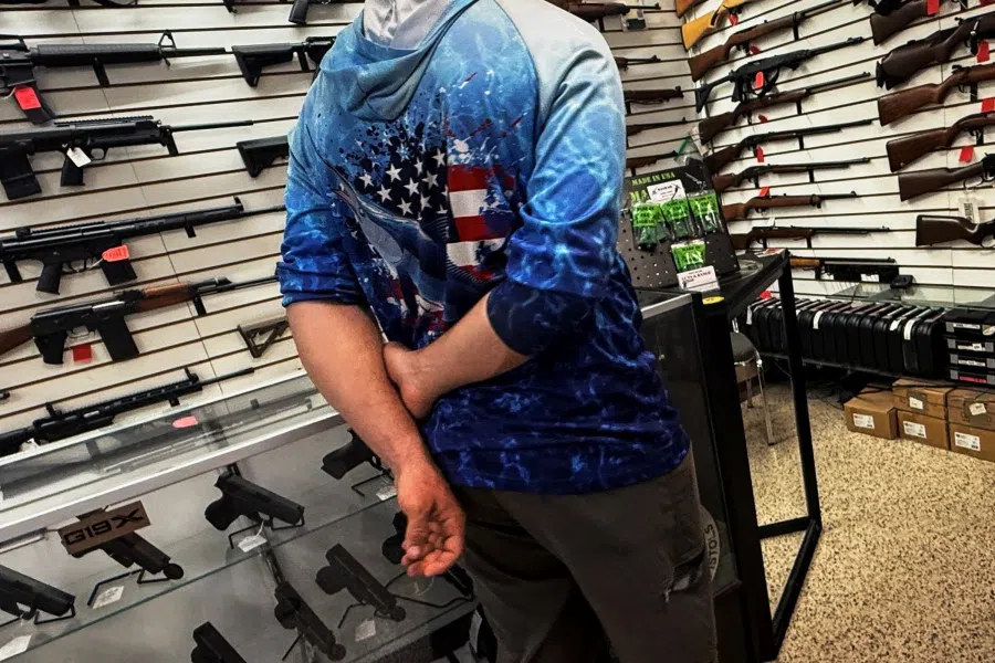 A man looks at various guns for sale at a gun shop in Port Charlotte, Florida, US, 13 September 2025.