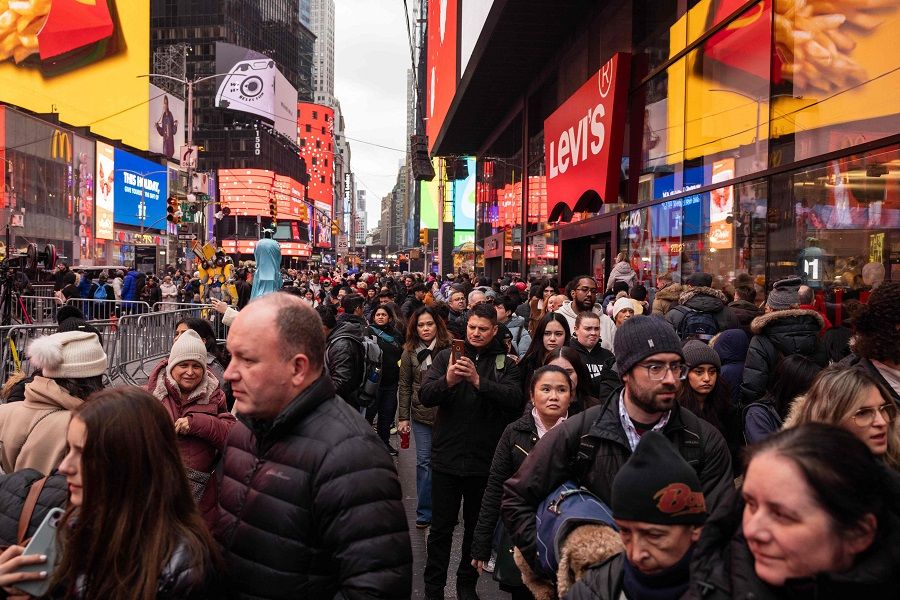People walk in Times Square on 30 December 2023 in New York City, US. (Yuki Iwamura/AFP)