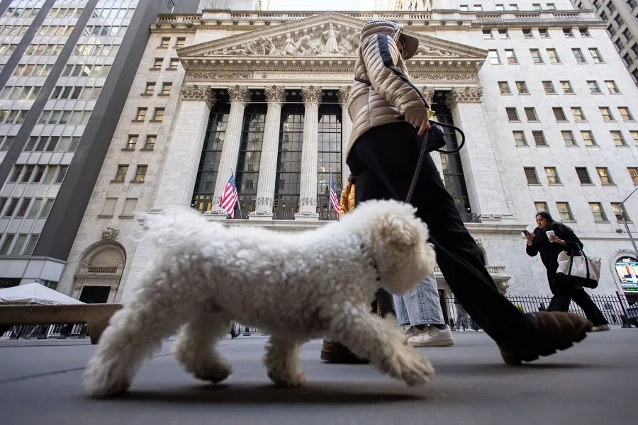 A pedestrian walks a dog in front of the New York Stock Exchange (NYSE) in New York, US, on 17 April 2025. (Michael Nagle/Bloomberg)