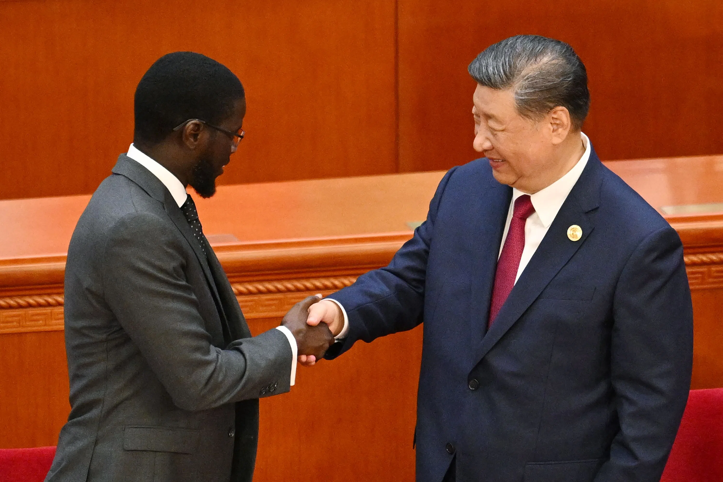 China’s President Xi Jinping shakes hands with Senegal President Bassirou Diomaye Faye at the end of the opening ceremony of the Forum on China-Africa Cooperation (FOCAC) in Beijing’s Great Hall of the People on 5 September 2024.