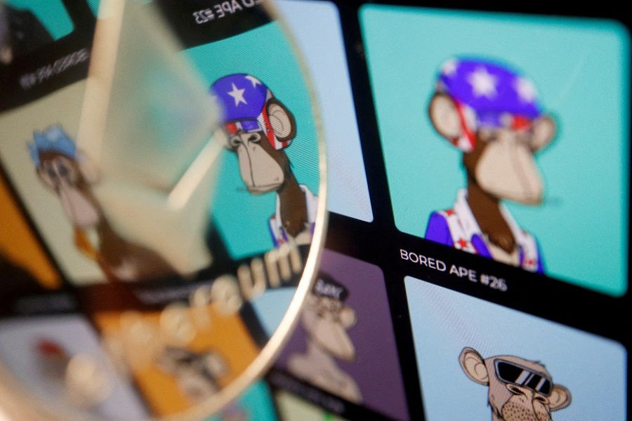 A representation of cryptocurrency Ethereum is seen next to non-fungible tokens (NFTs) of Yuga Labs "Bored Ape Yacht Club" collection displayed on its website, in this illustration picture taken 24 March 2022. (Florence Lo/Illustration/File Photo/Reuters)