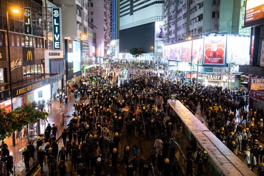 Demonstrators stand off against riot police during a protest in the Causeway Bay district of Hong Kong, China, on 31 August 2019. (Kyle Lam/Bloomberg)