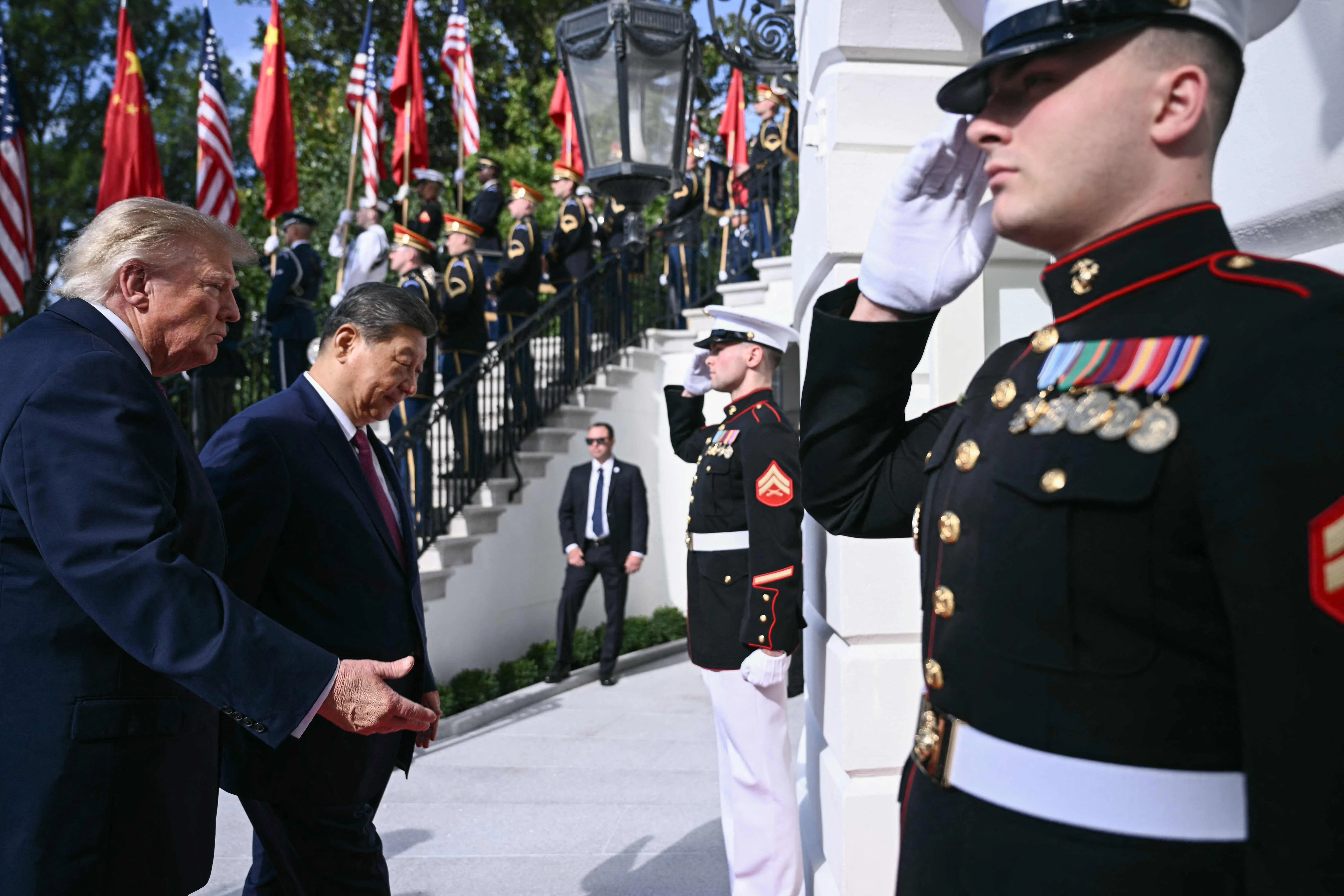 US President Donald Trump walks with China's President Xi Jinping upon Xi's arrival at the South Portico of the White House in Washington, DC, 24 September 2026.