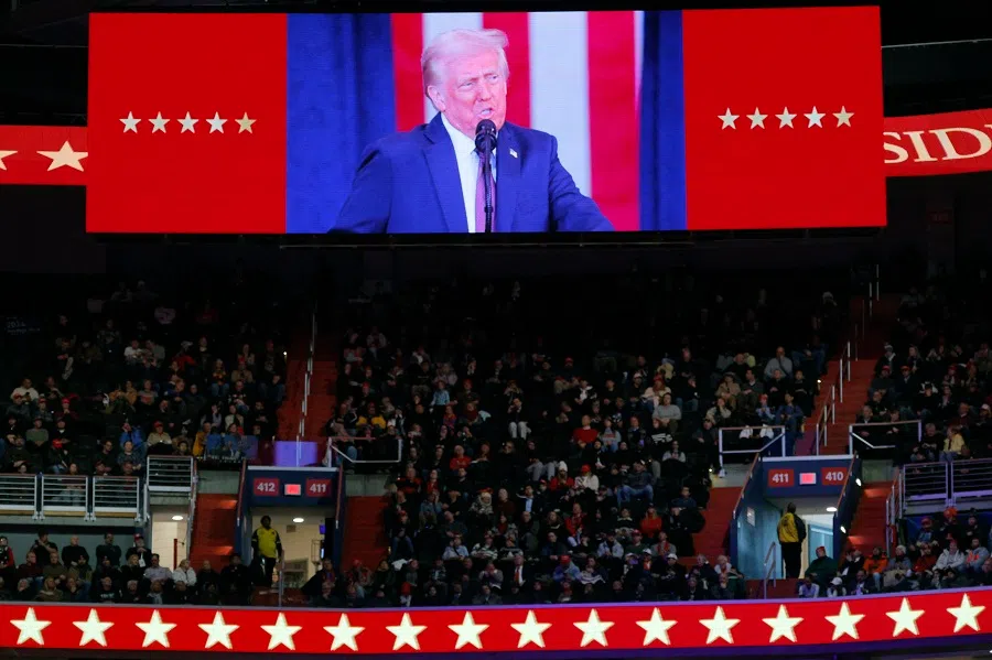 US President Donald Trump is shown on a screen while he delivers a speech on the inauguration day of his second presidential term, inside Capital One, in Washington, US, on 20 January 2025. (Brian Snyder/Reuters)